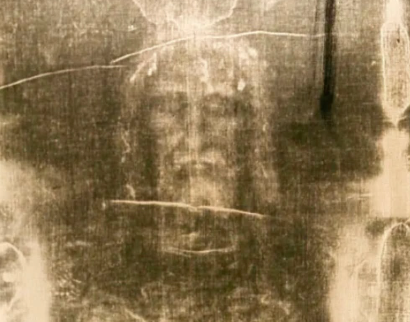 Shroud of Turin with the traditional tomb site in the background